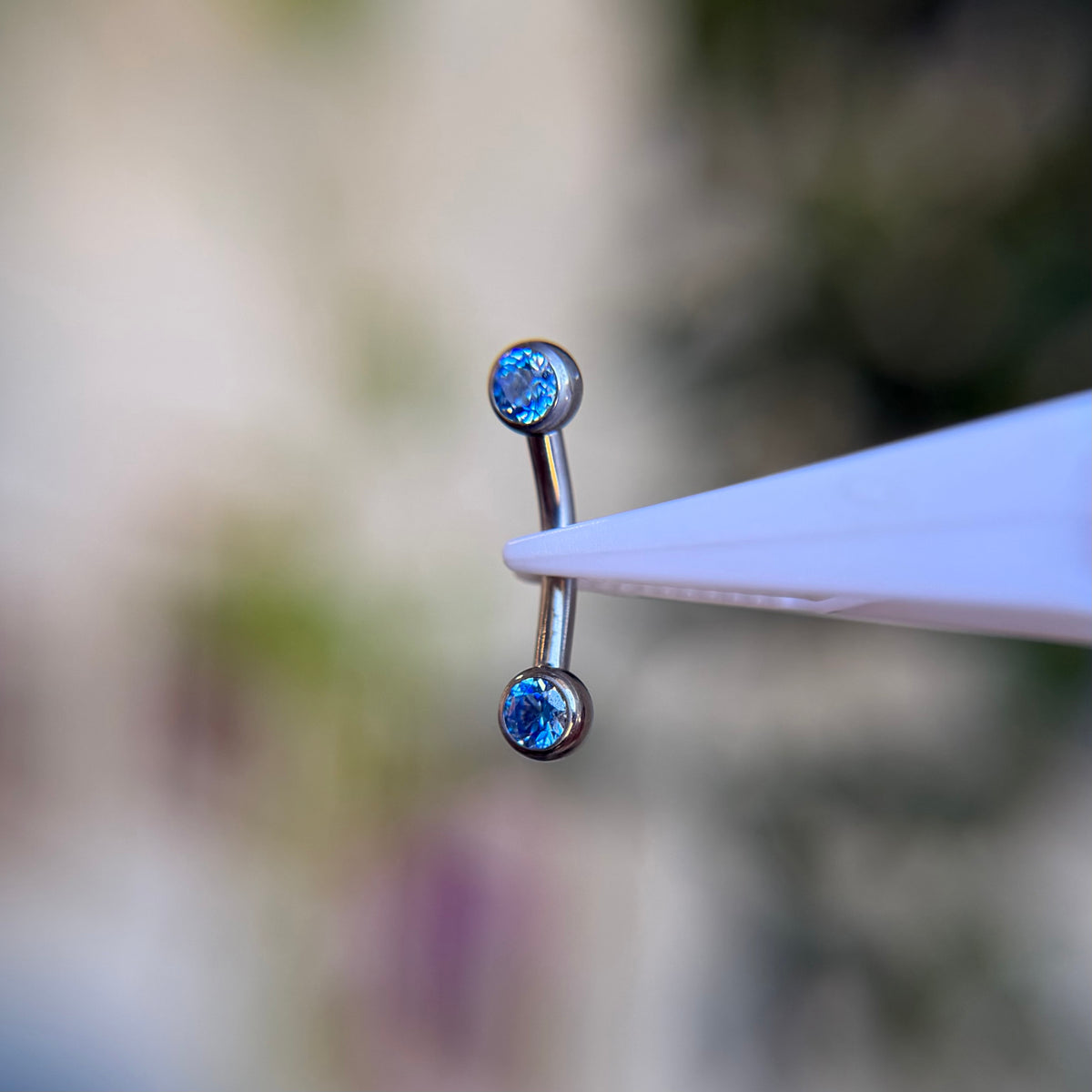 Titanium Faceted Side Gem Curved Barbell - Arctic Blue