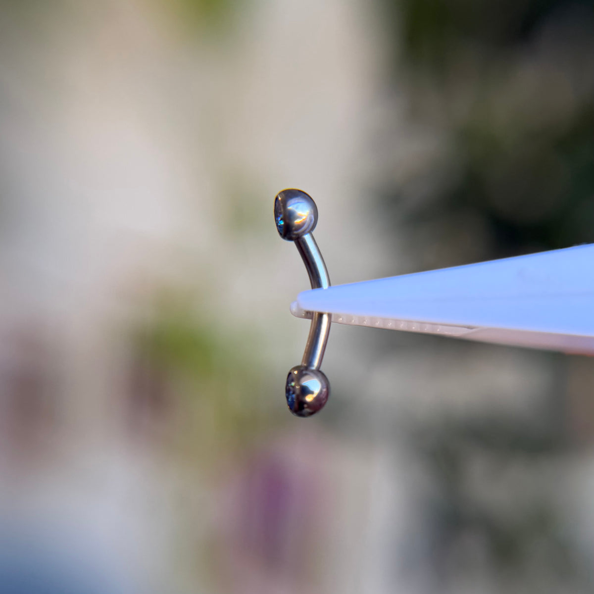 Titanium Faceted Side Gem Curved Barbell - Arctic Blue